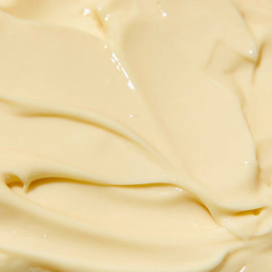 Close-up of a creamy, smooth cosmetic product with a pale yellow hue.