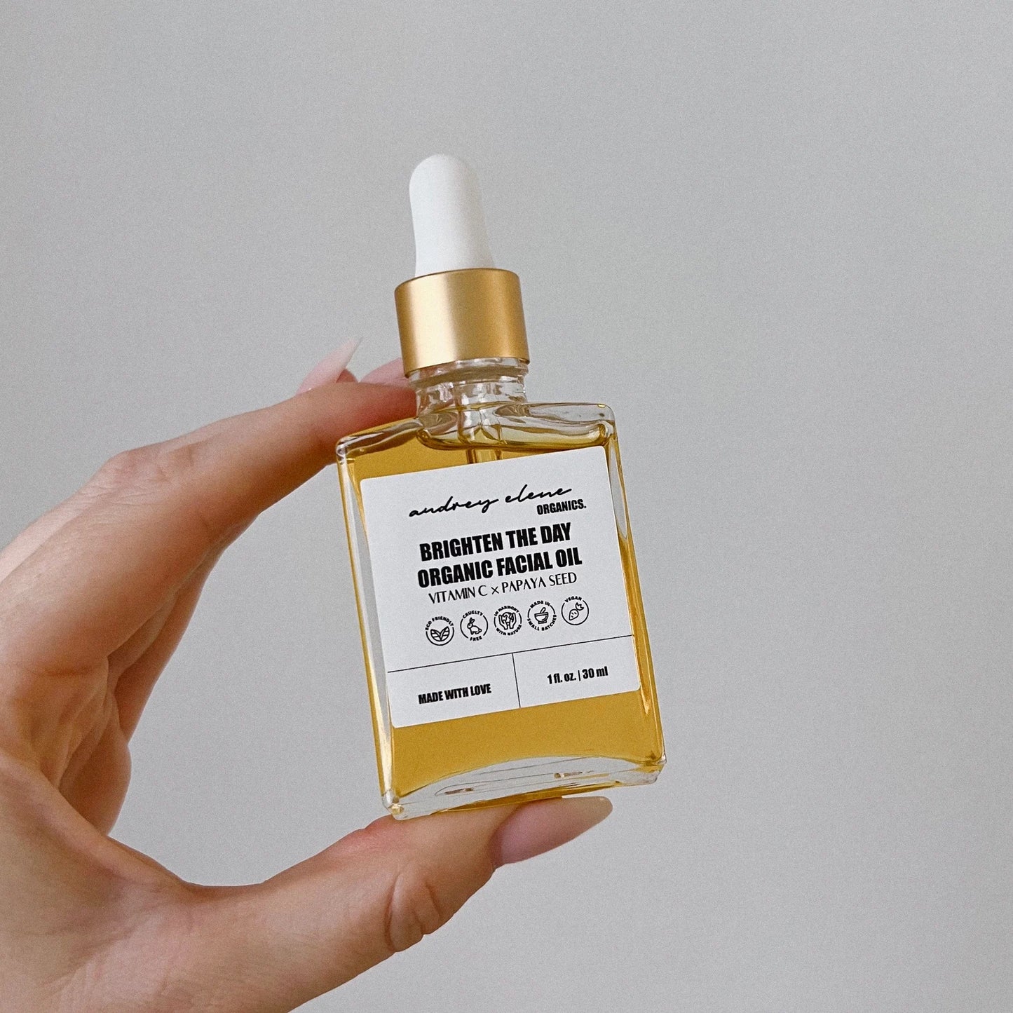 Vitamin C and Papaya Seed Organic Facial Oil bottle against white background.