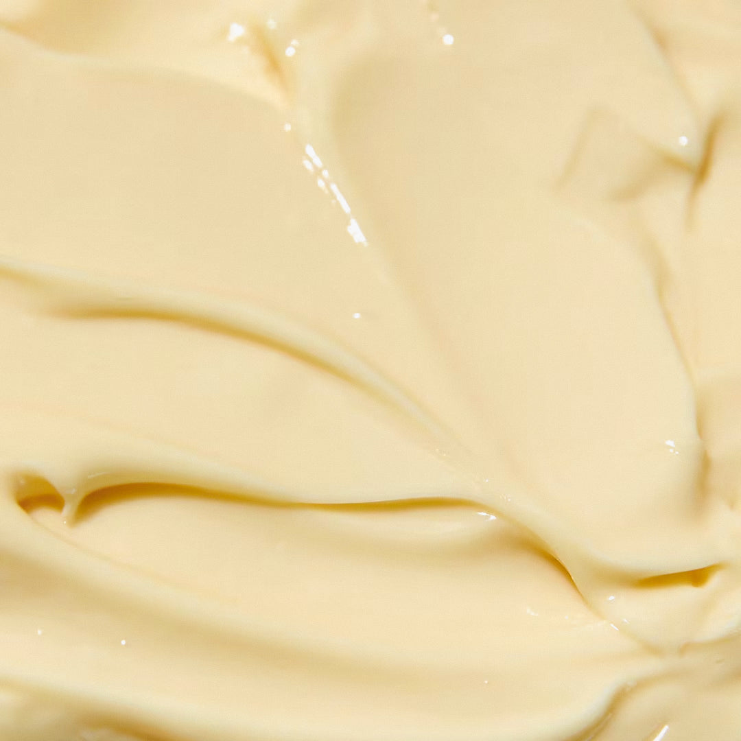 Close-up of a creamy, smooth cosmetic product with a pale yellow hue.