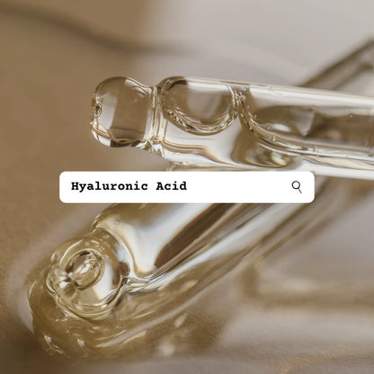Two droppers with clear liquid and a text box labeled 'Hyaluronic Acid' on a beige background.