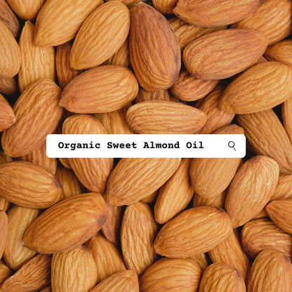 Close-up of almonds with a search bar overlay displaying 'Organic Sweet Almond Oil'.