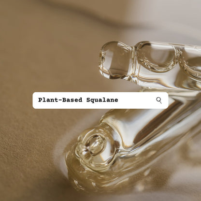 Close-up of plant-based squalane droplets with a textured background