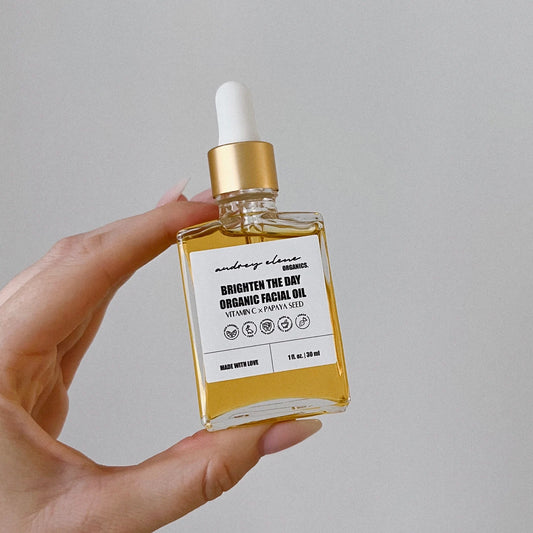 Vitamin C and Papaya Seed Organic Facial Oil bottle against white background.